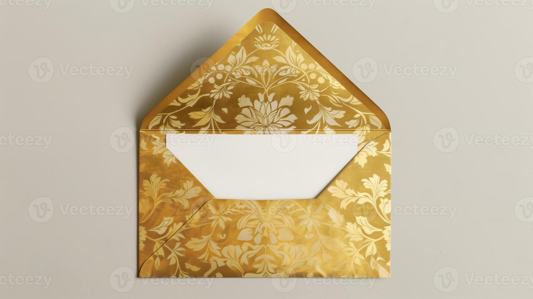 An envelope with gold foil on it, with the top open placed against a gray background. photo