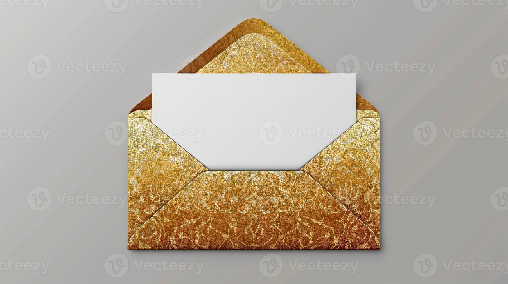An envelope with gold foil on it, with the top open placed against a gray background. photo