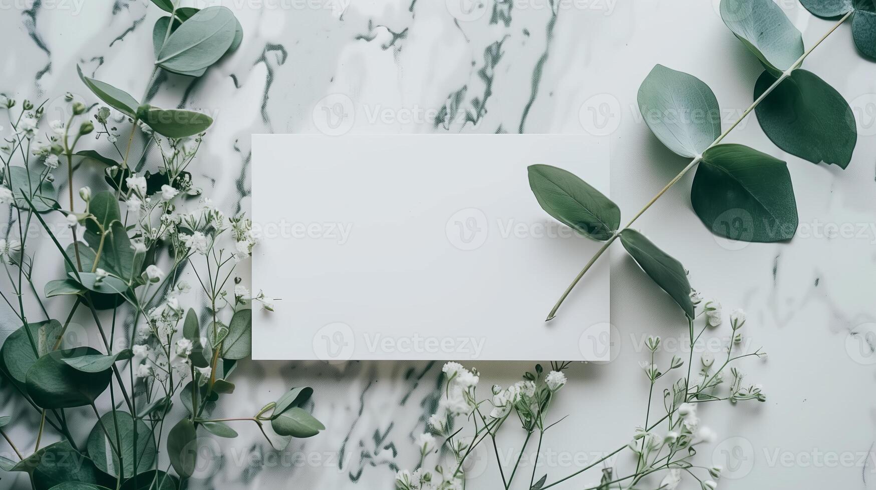 A lat lay card mockup adorned with eucalyptus branche and flowers. photo