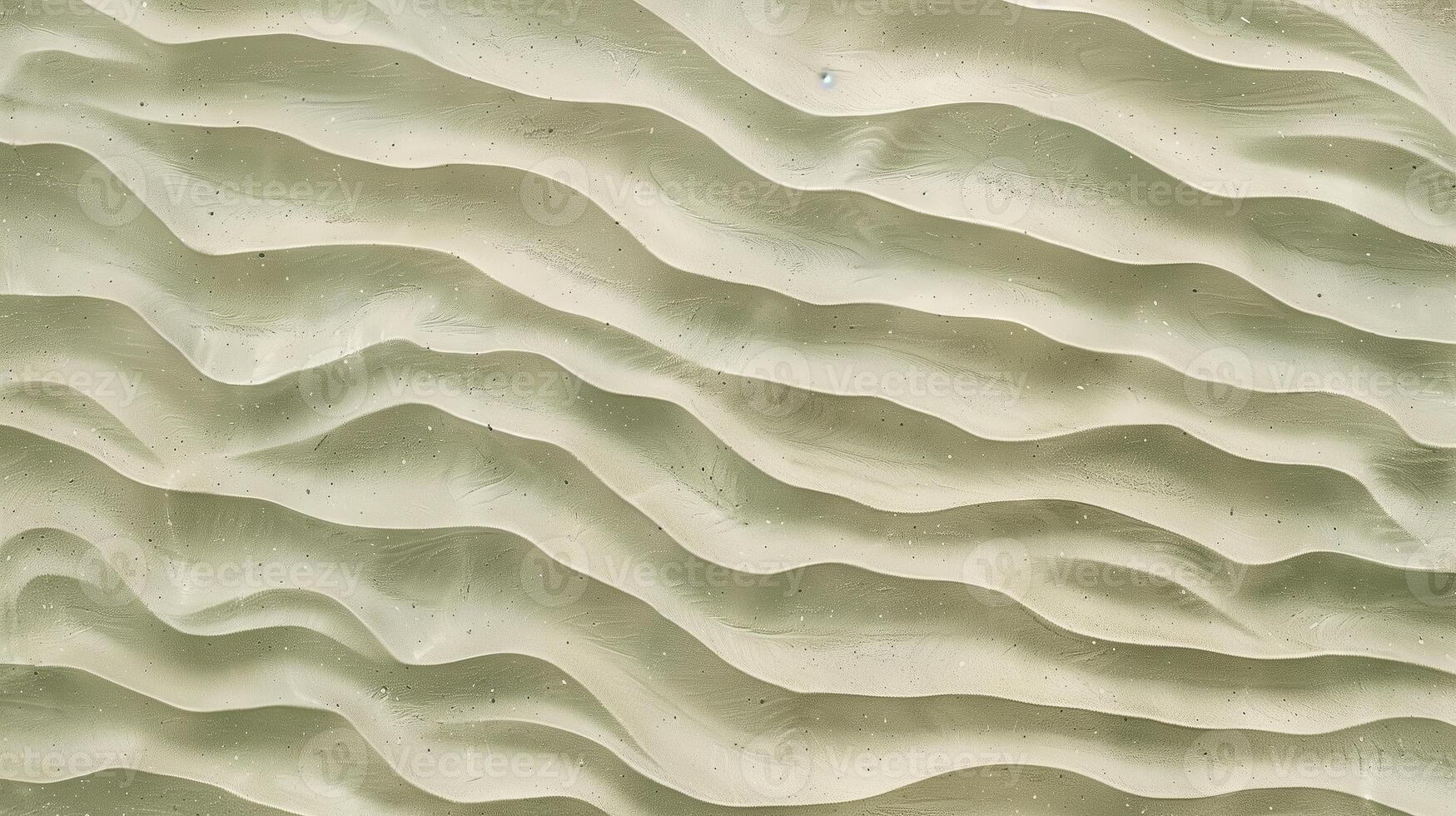 A texture of ripples on sand, with small waves on the surface, light green tint. photo