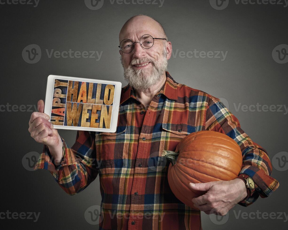 Happy Halloween - senior man with pumpkin photo