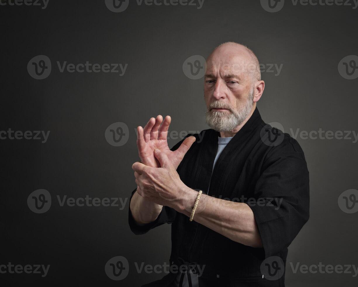 senior man is practicing reflexology therapy photo