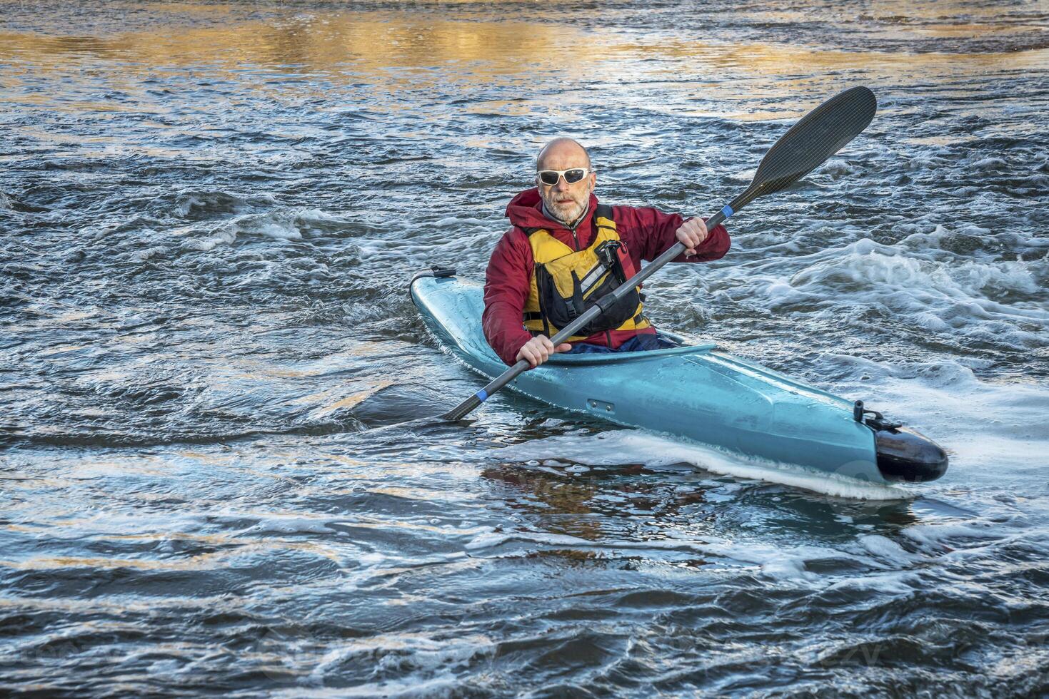 senior male paddler kayaking photo