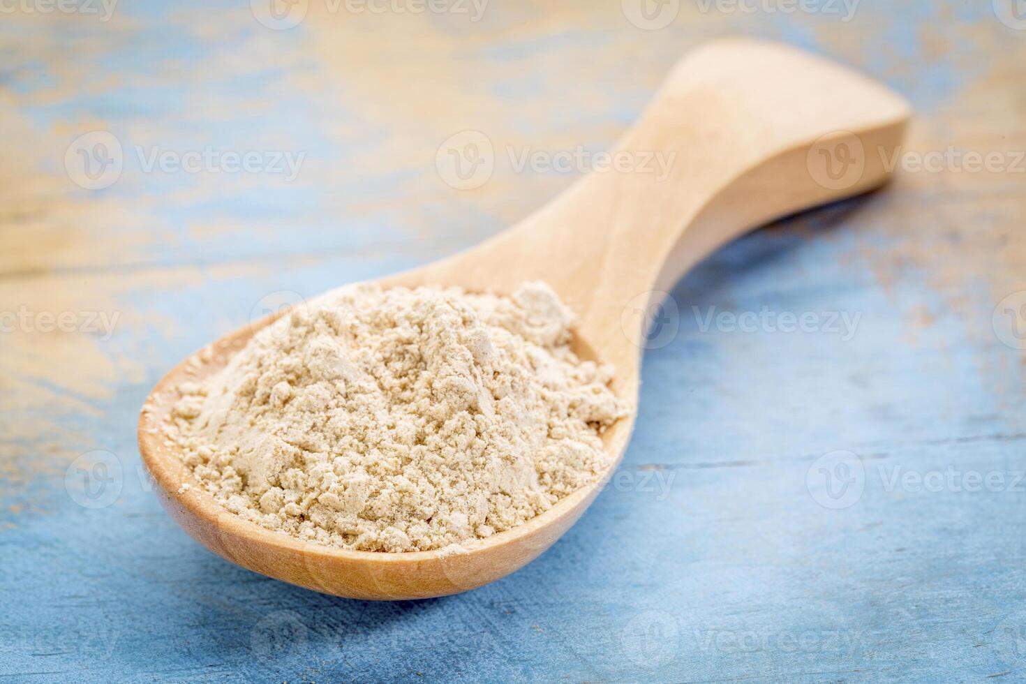 maca root powder on wooden spoon photo