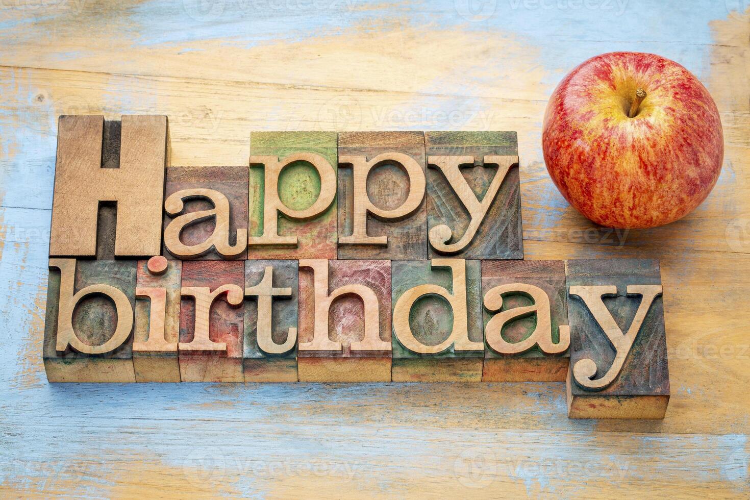 Happy Birthday in wood type with apple photo