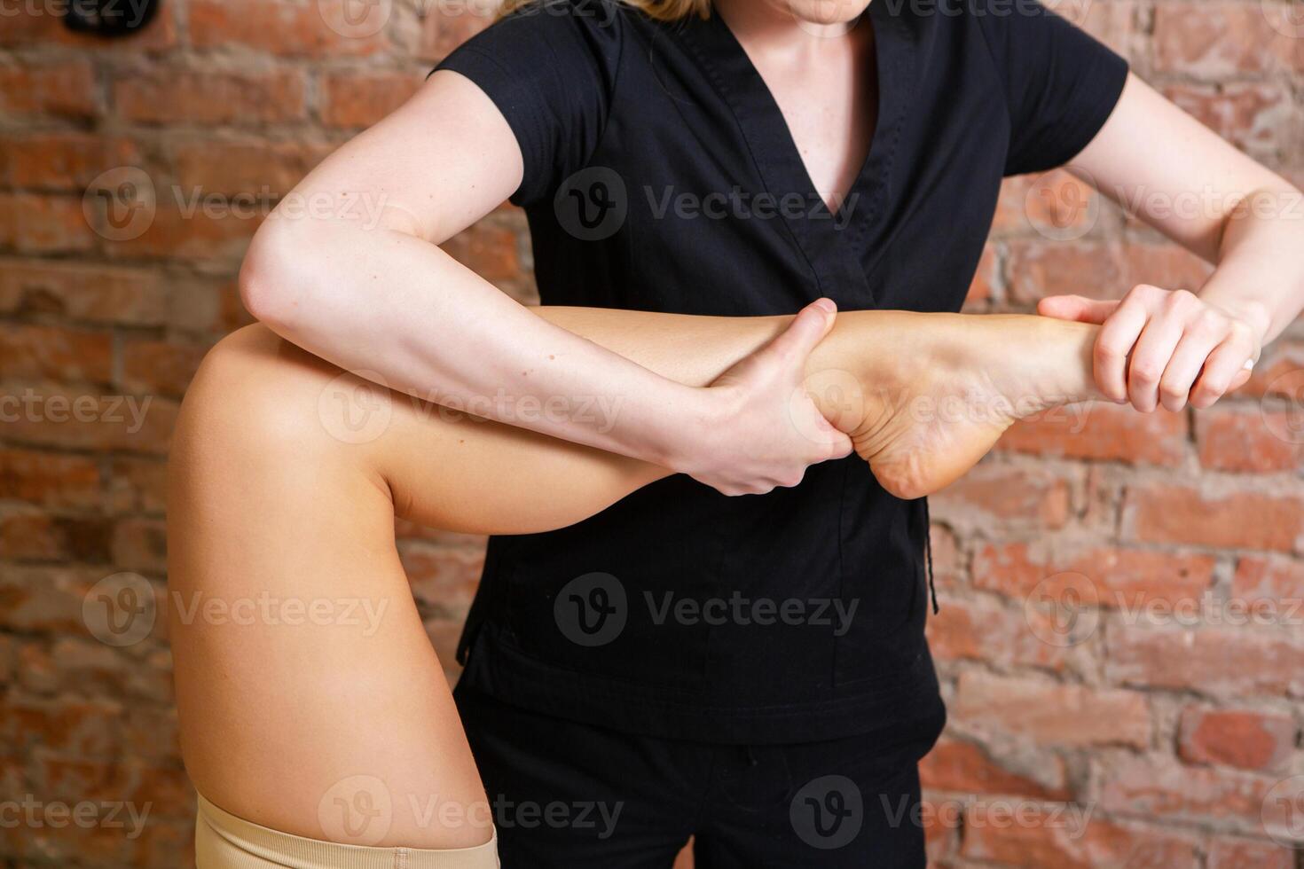Young attractive Caucasian woman receiving professional rehabilitation procedure in medical office. Therapist doing healing treatment on woman's back. photo