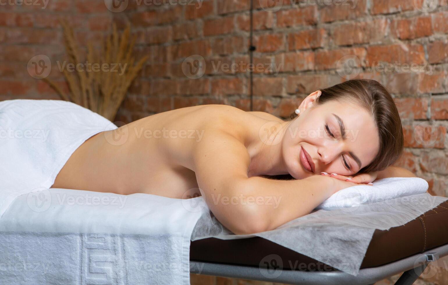 Portrait of a young woman in a spa salon. Beauty treatment. photo
