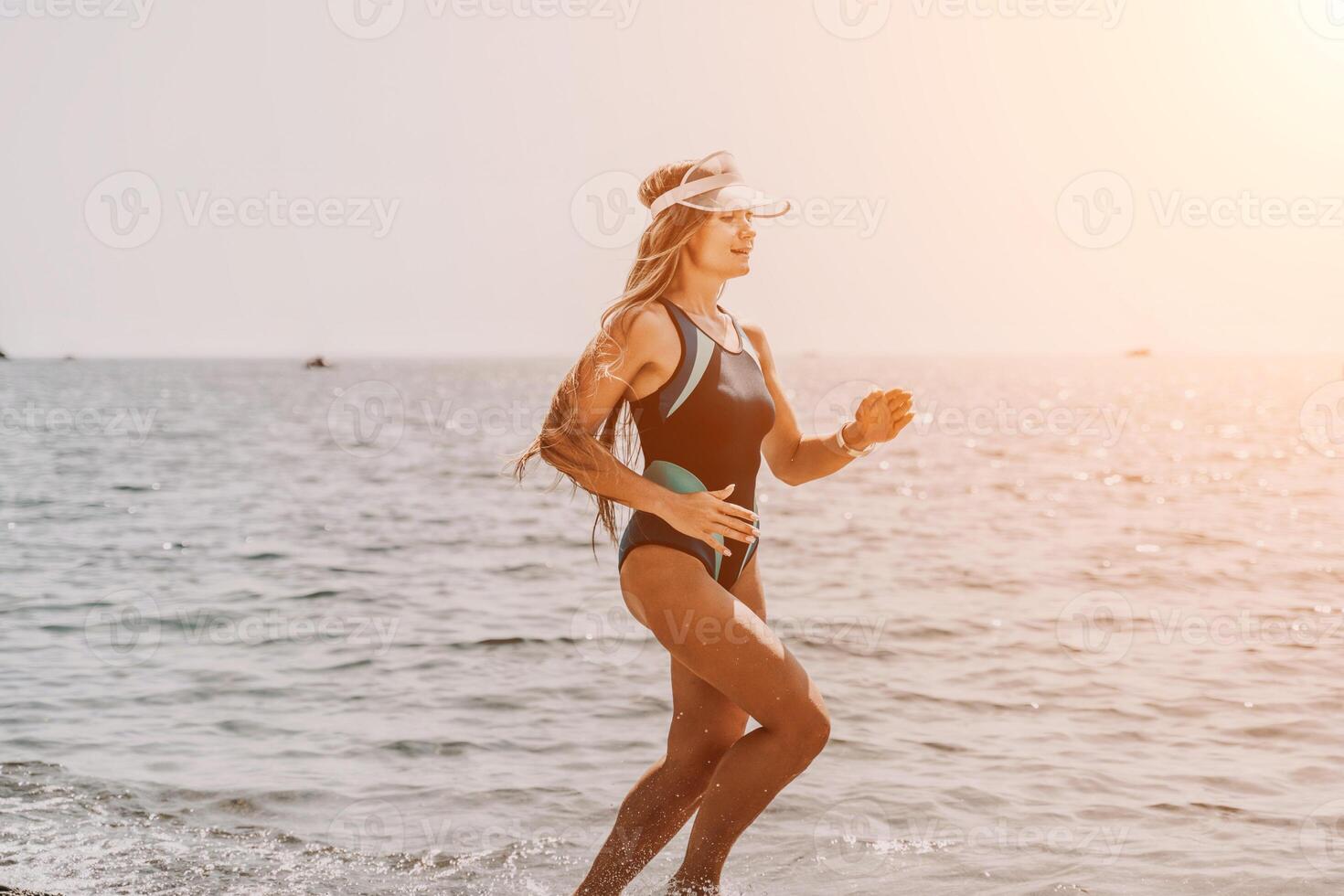 Woman travel summer sea. A happy tourist in a blue bikini enjoying the scenic view of the sea and volcanic mountains while taking pictures to capture the memories of her travel adventure. photo