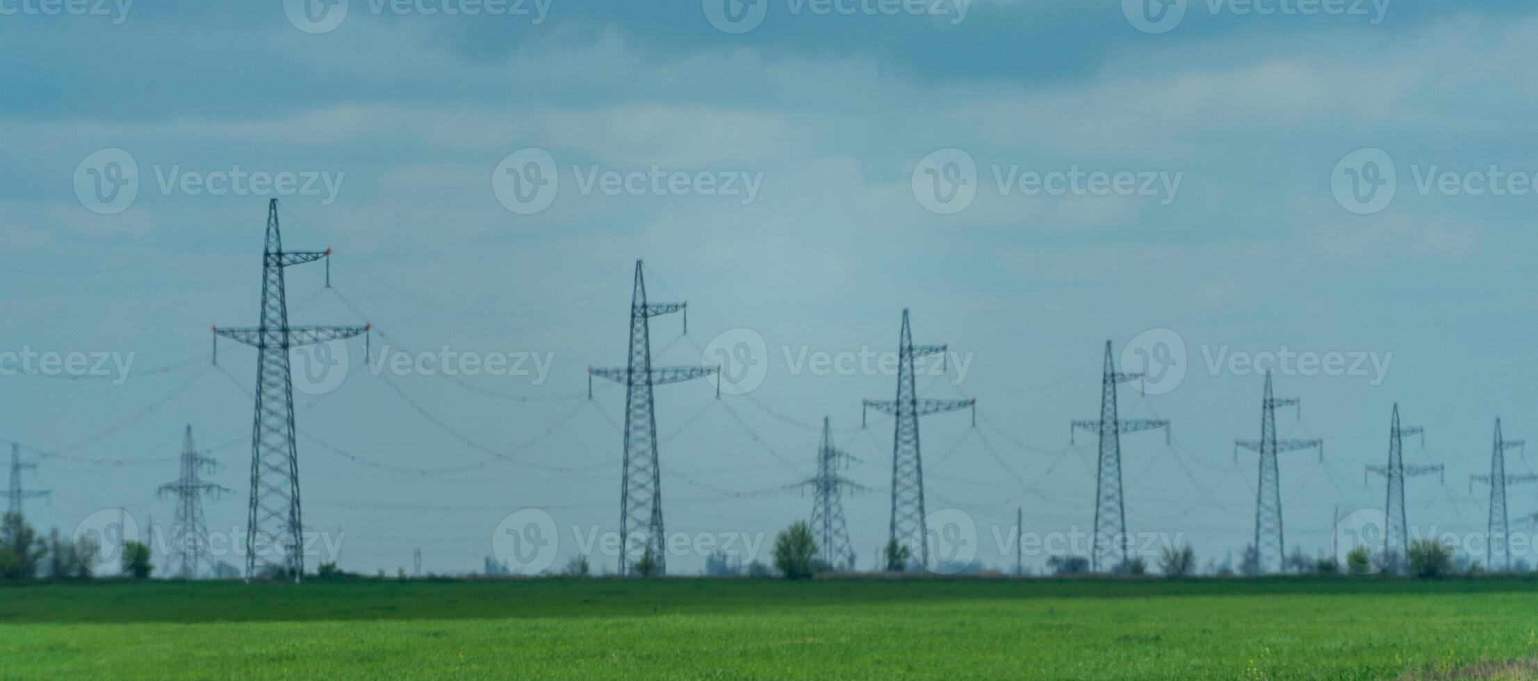 High voltage towers with sky background. Power line support with wires for electricity transmission. High voltage grid tower with wire cable at distribution station. Energy industry, energy saving photo