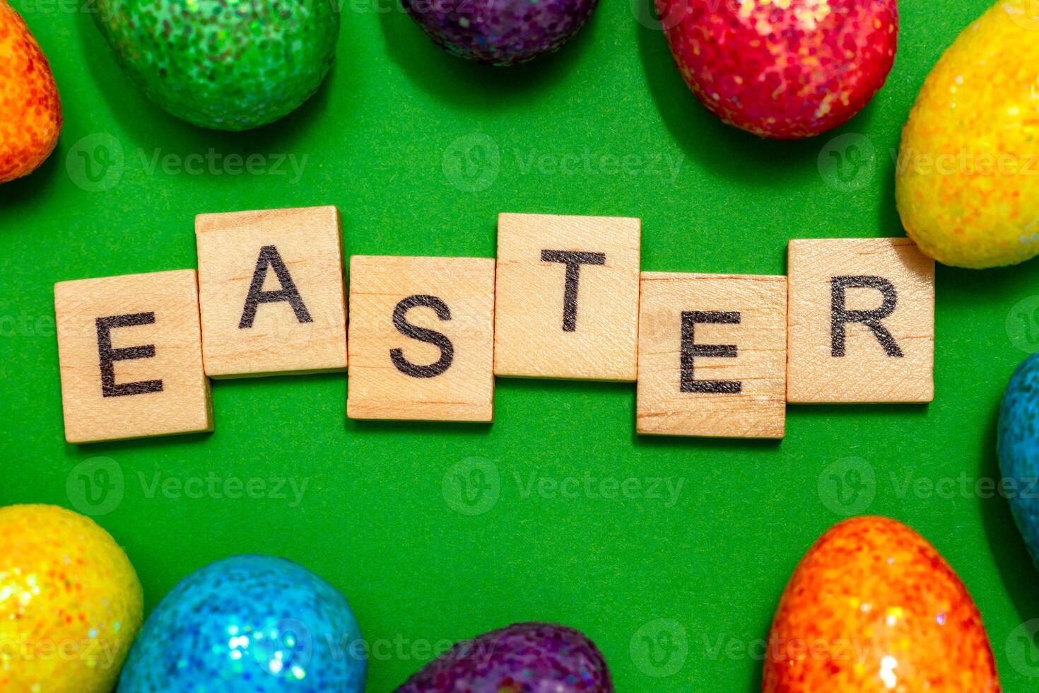 Easter card with eggs on a green background and the inscription Easter. Easter spring break concept photo