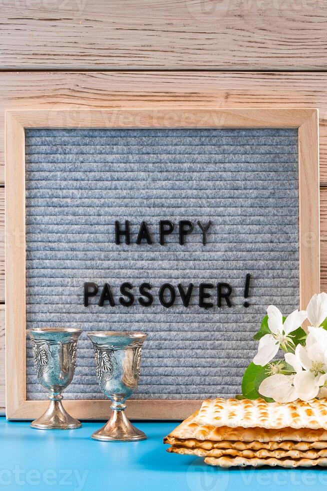 Happy Passover. Metal wine glasses and traditional Jewish matzo bread. photo