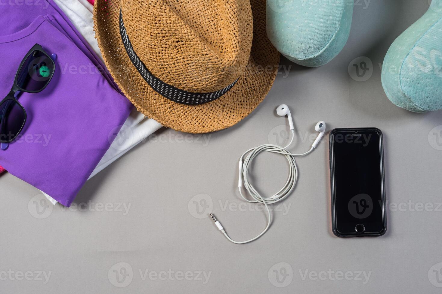 Mock up of summer traveling stuff on grey background. photo