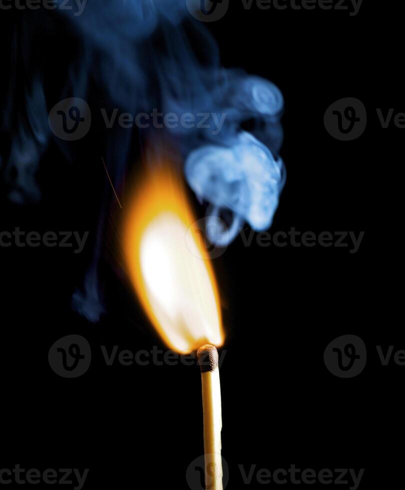 Wooden match burning on a black background photo