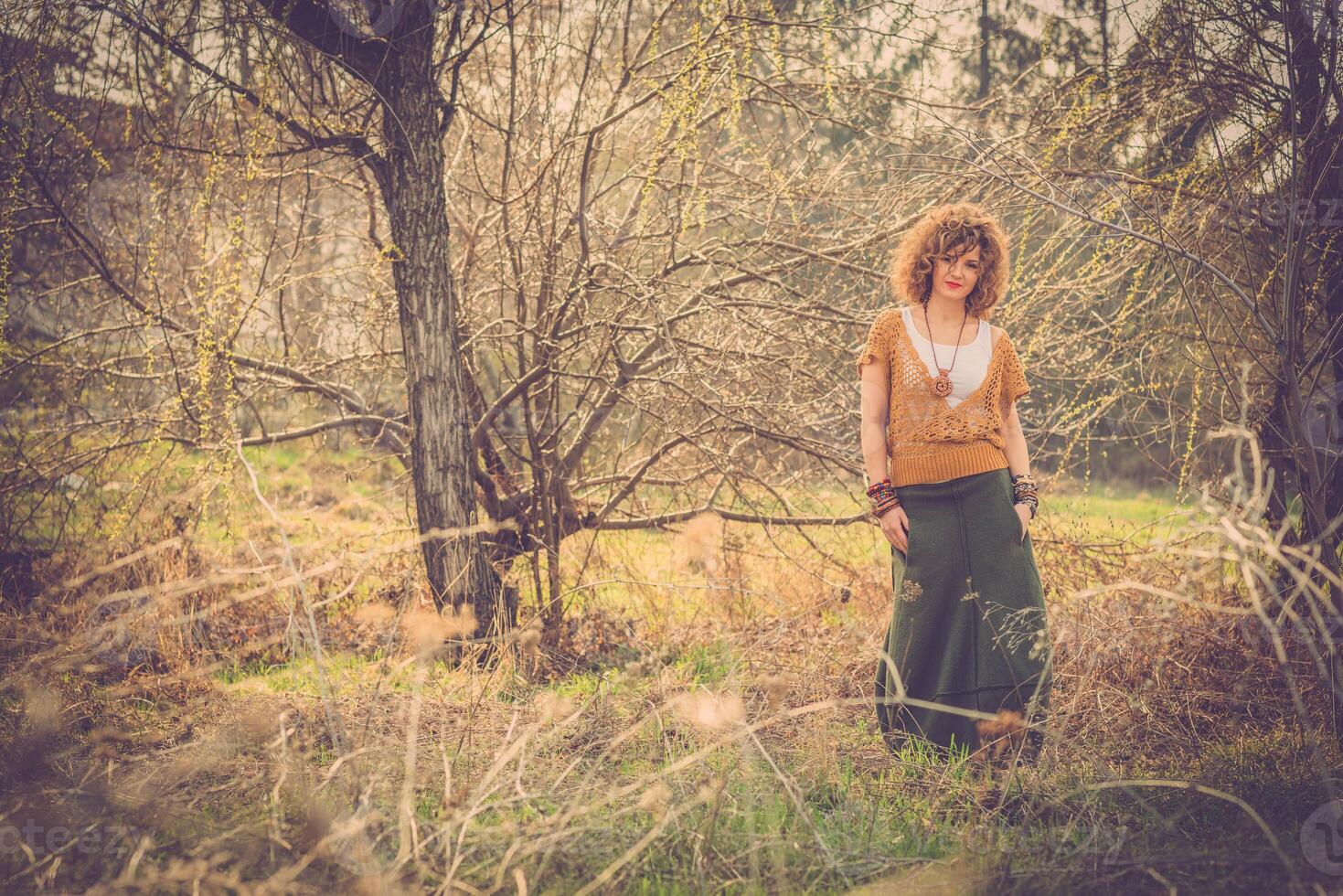 Fashion shot of a beautiful boho style girl on nature background. Boho, hippie. photo