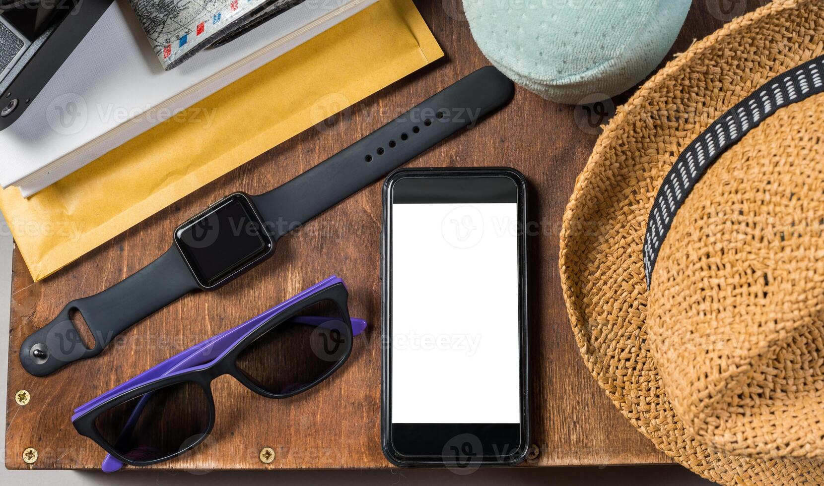 Packed suitcase of vacation items on wooden background. photo