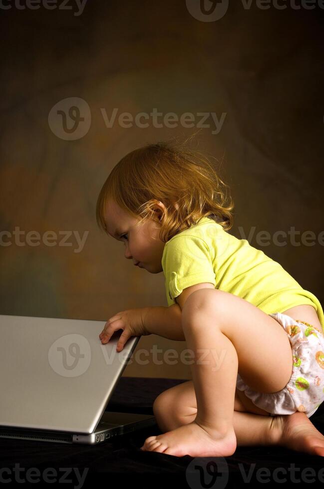 Small girl works with the computer photo