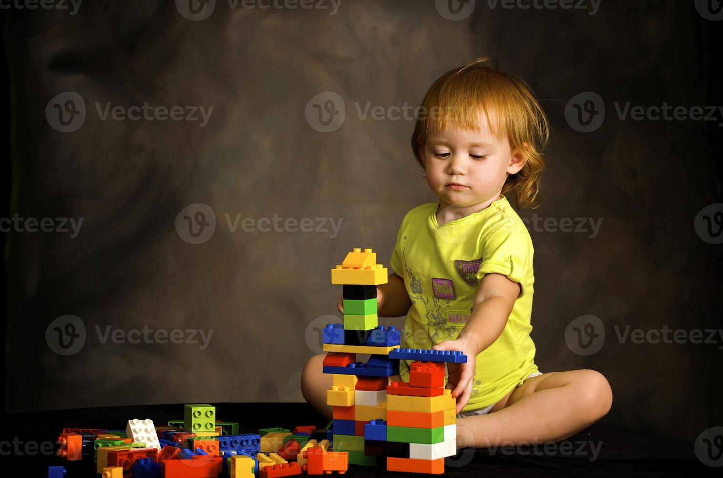 Small girl plays with the designer photo