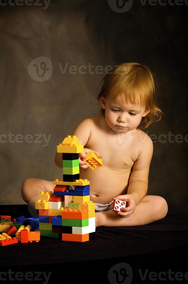 Small girl plays with the designer photo
