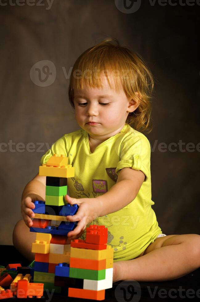 Small girl plays with the designer photo