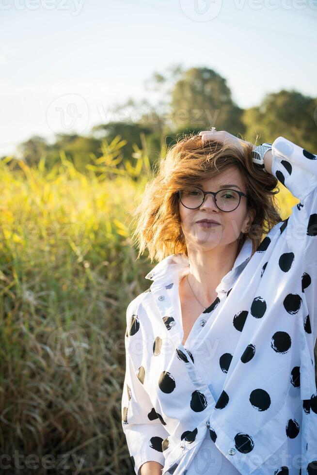 Fashion shot of a beautiful boho style girl on nature background. Boho, hippie. photo