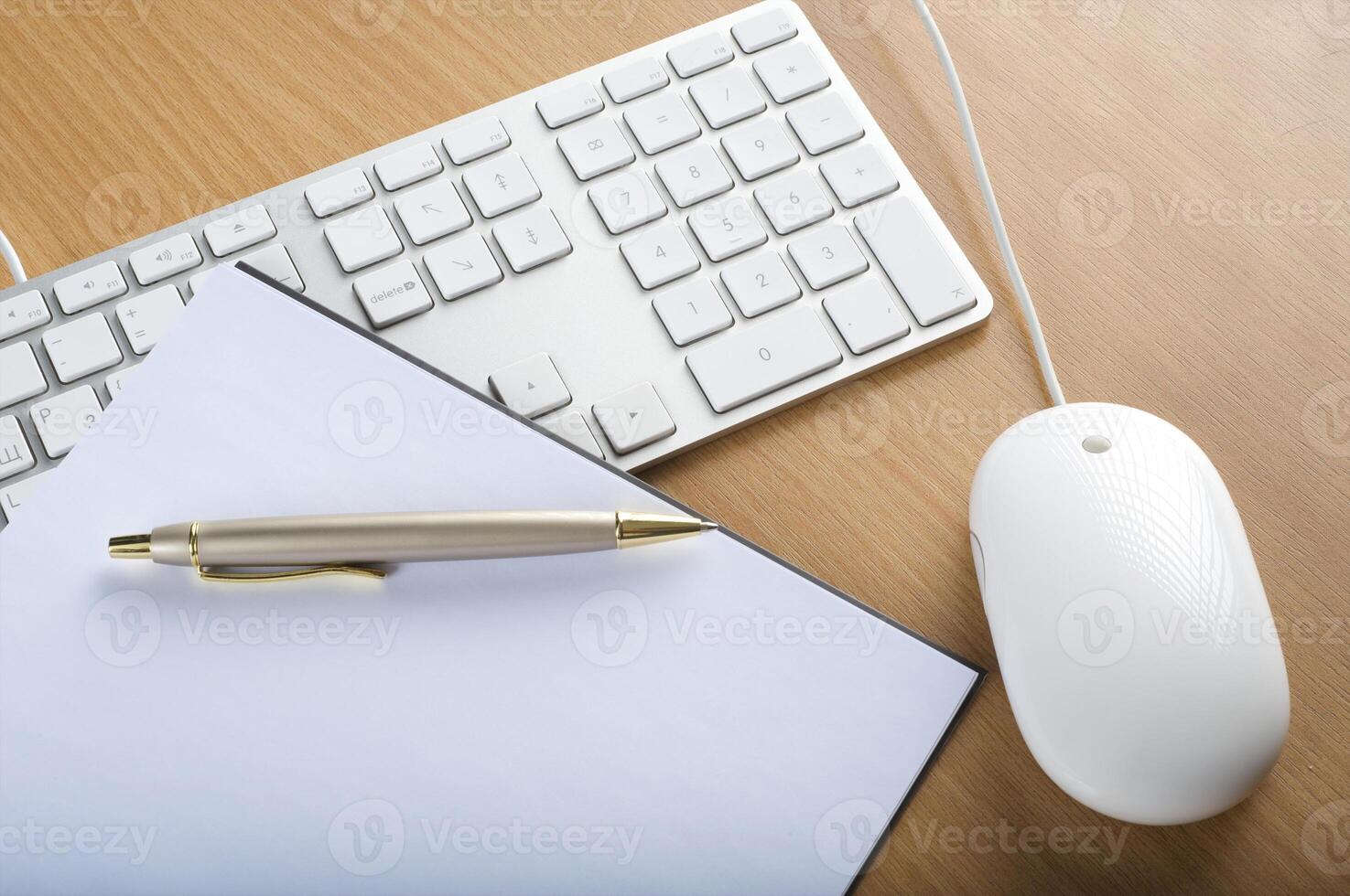 Modern aluminum computer keyboards, mouse and notebook photo