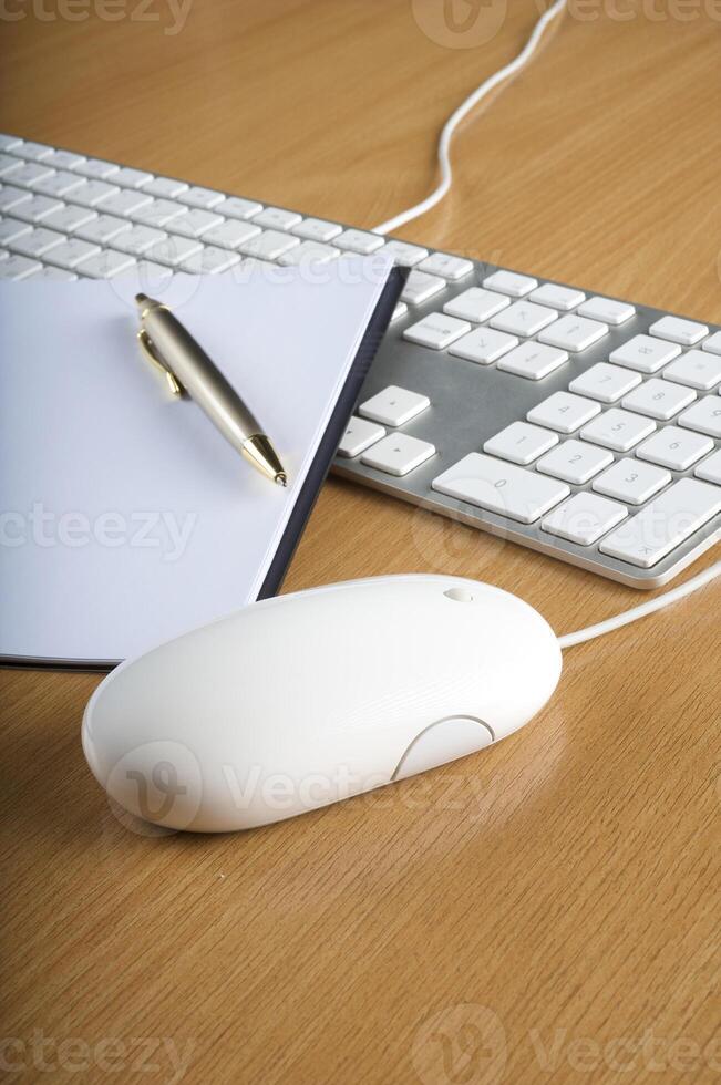 Modern aluminum computer keyboards, mouse and notebook photo