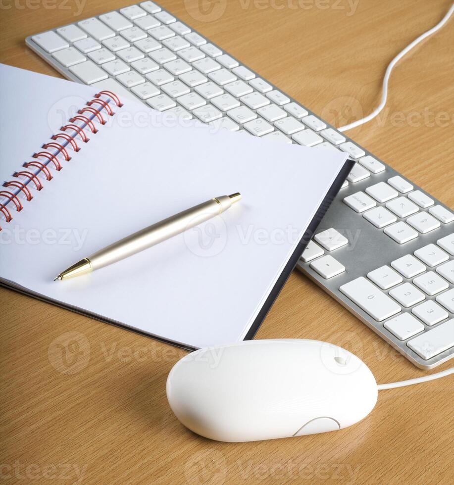 Modern aluminum computer keyboards, mouse and notebook photo