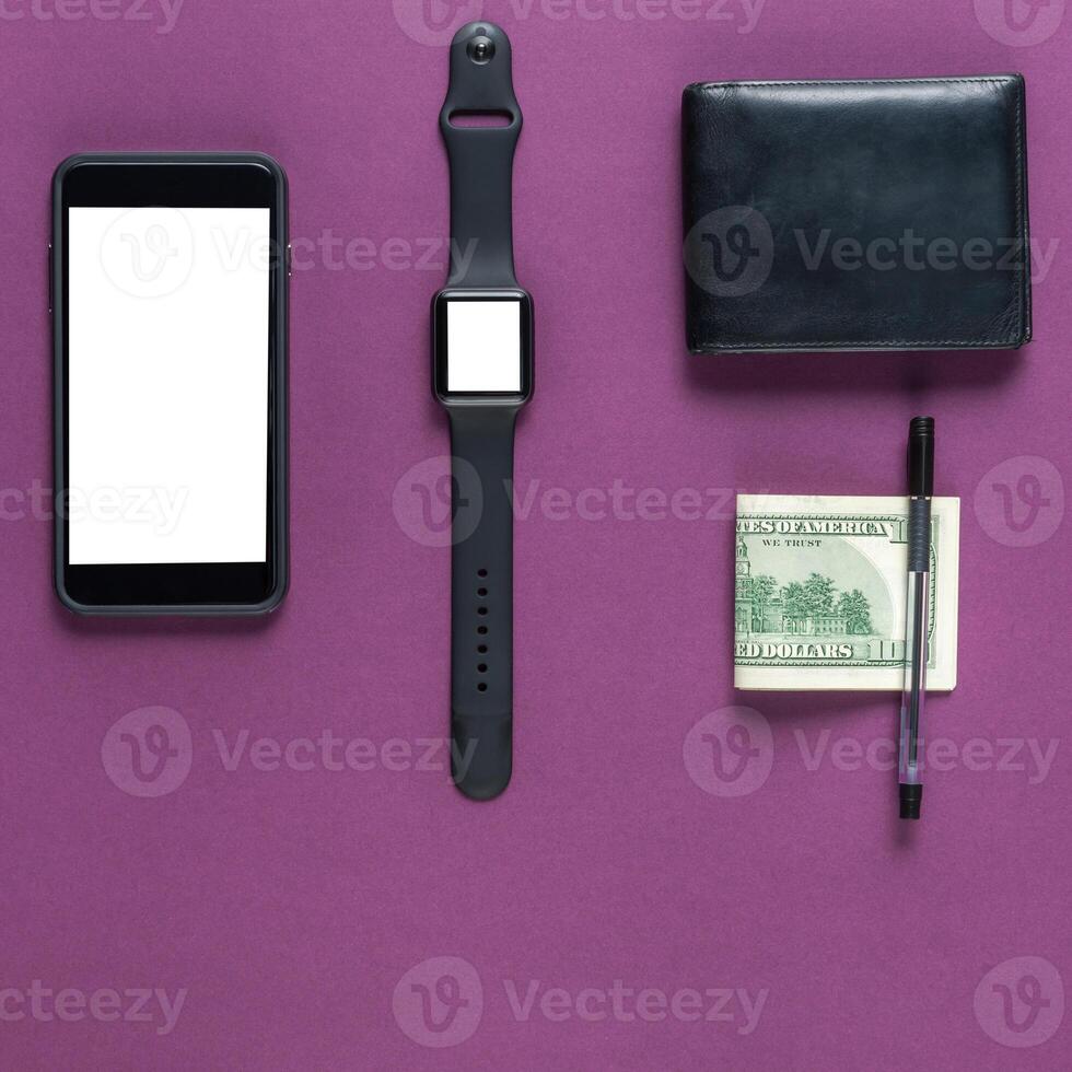 Business concept. Top view of dollars, watch, smartphone on color background photo
