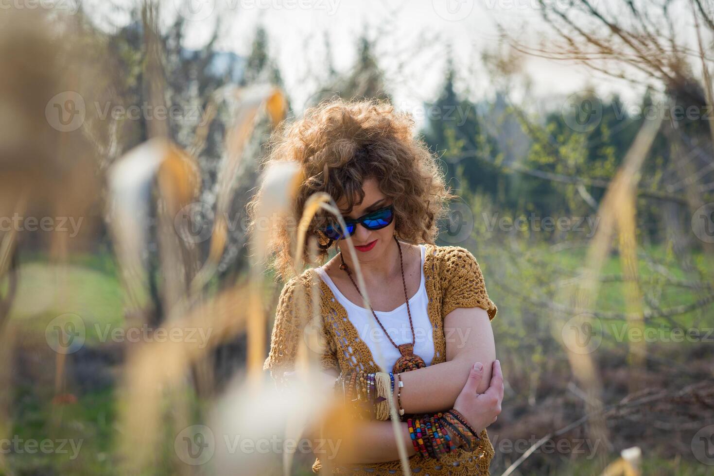 Fashion shot of a beautiful boho style girl on nature background. Boho, hippie photo