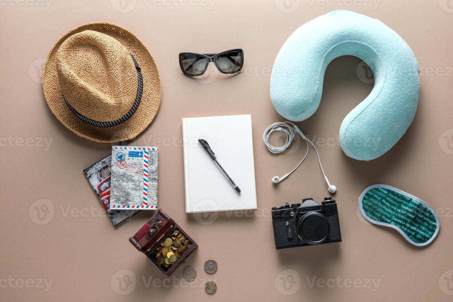 Packed suitcase of vacation items on wooden table, top view photo