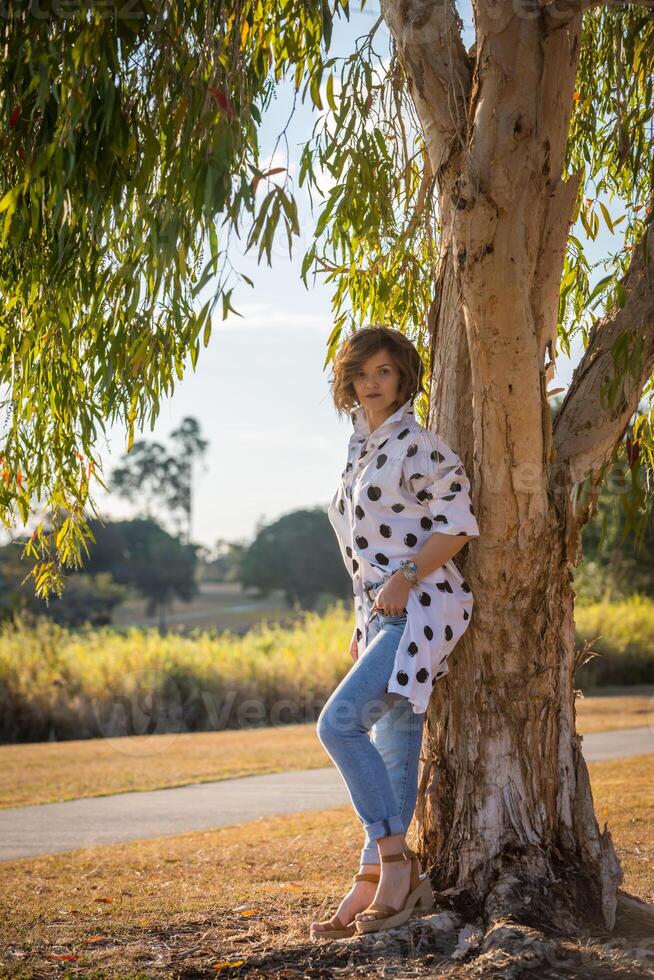 Fashion shot of a beautiful boho style girl on nature background. Boho, hippie. photo