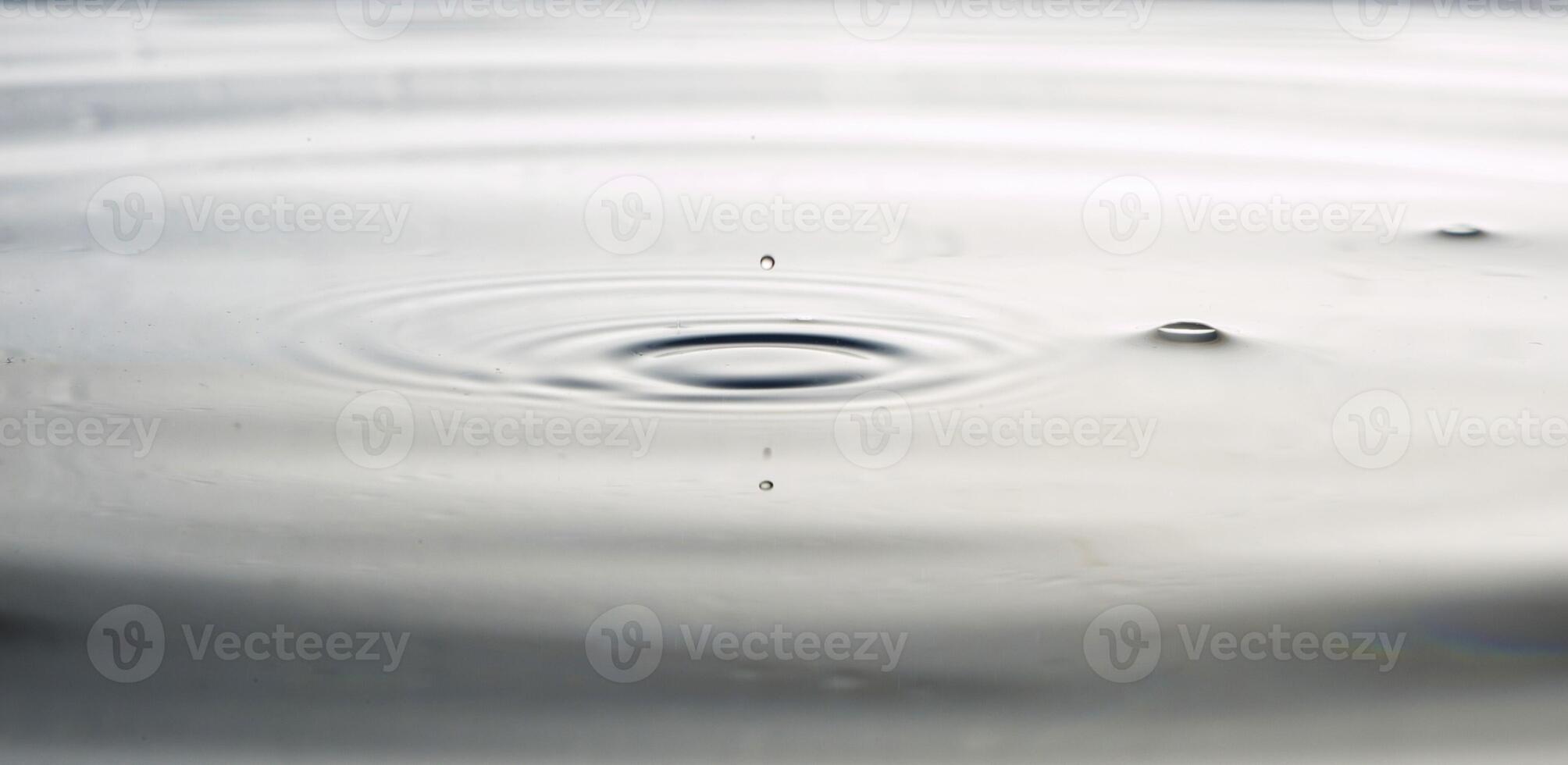 The round transparent drop of water, falls downwards photo