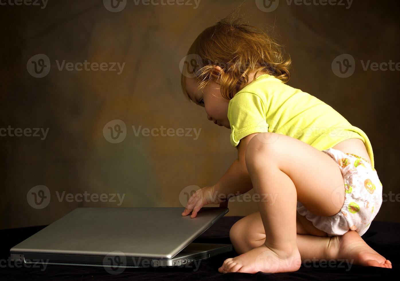 Small girl works with the computer photo