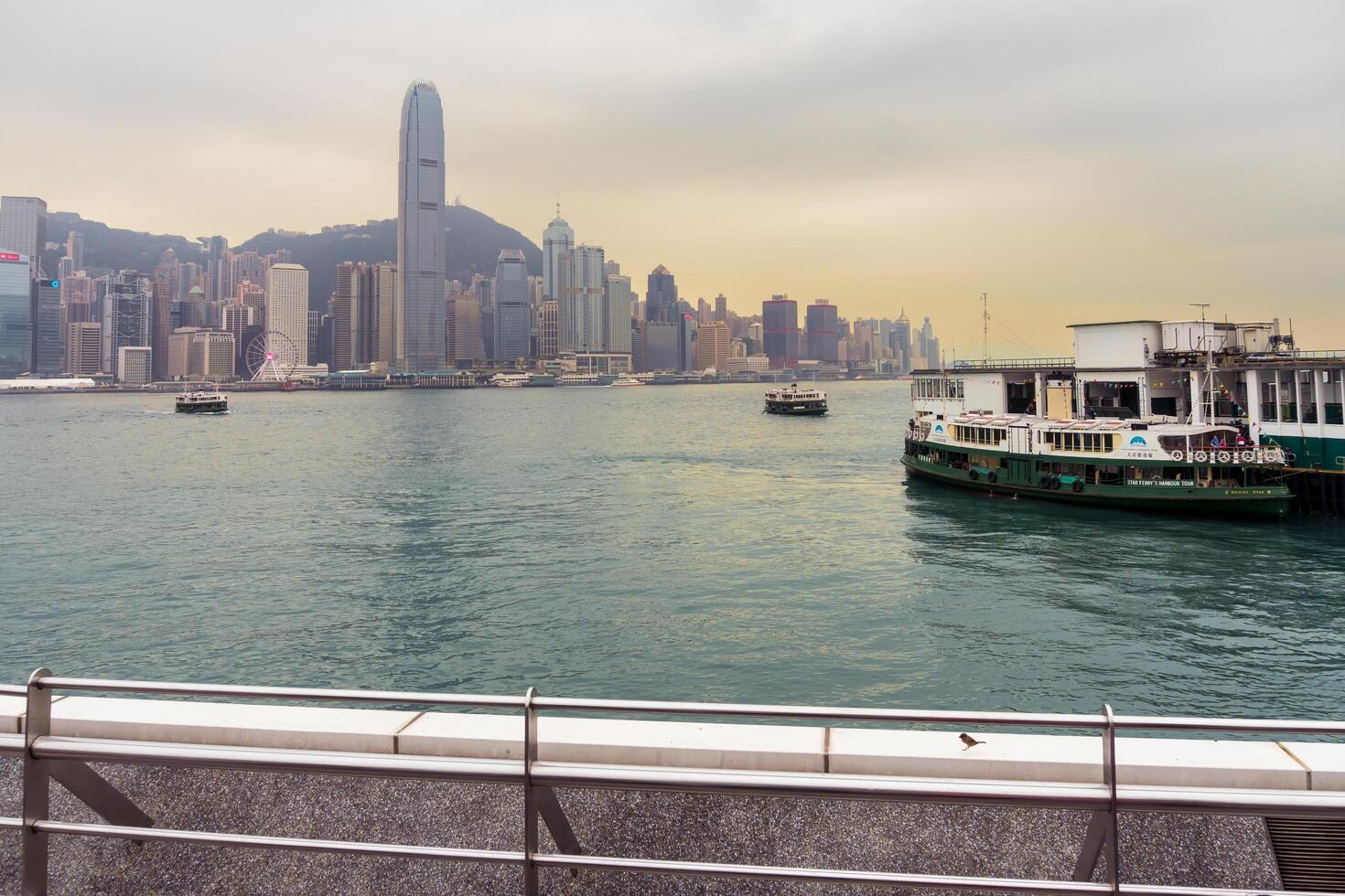 Hong Kong,March 25,2019-People strolling on the Avenue of star on the Victoria Harbour during a cloudy day photo