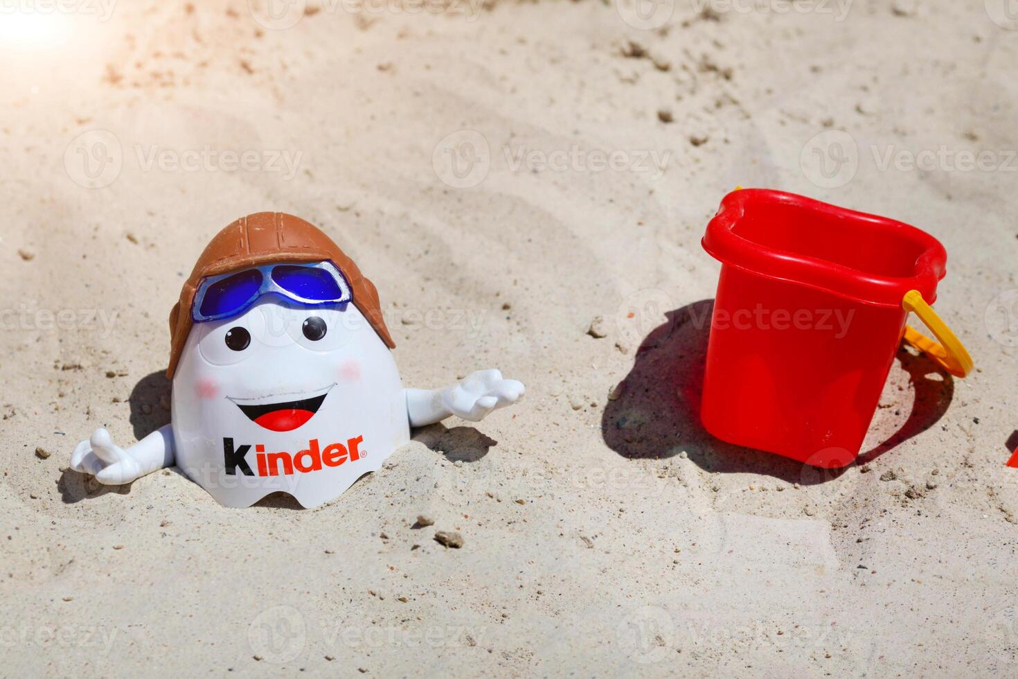 Kinder Surprise Kinderino Mascot Toys and paddles in the sand photo
