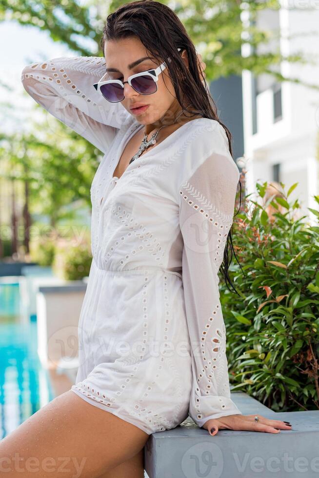 Beautiful  model in stylish summer outfit enjoying pool party .  Boho accsessroses. photo