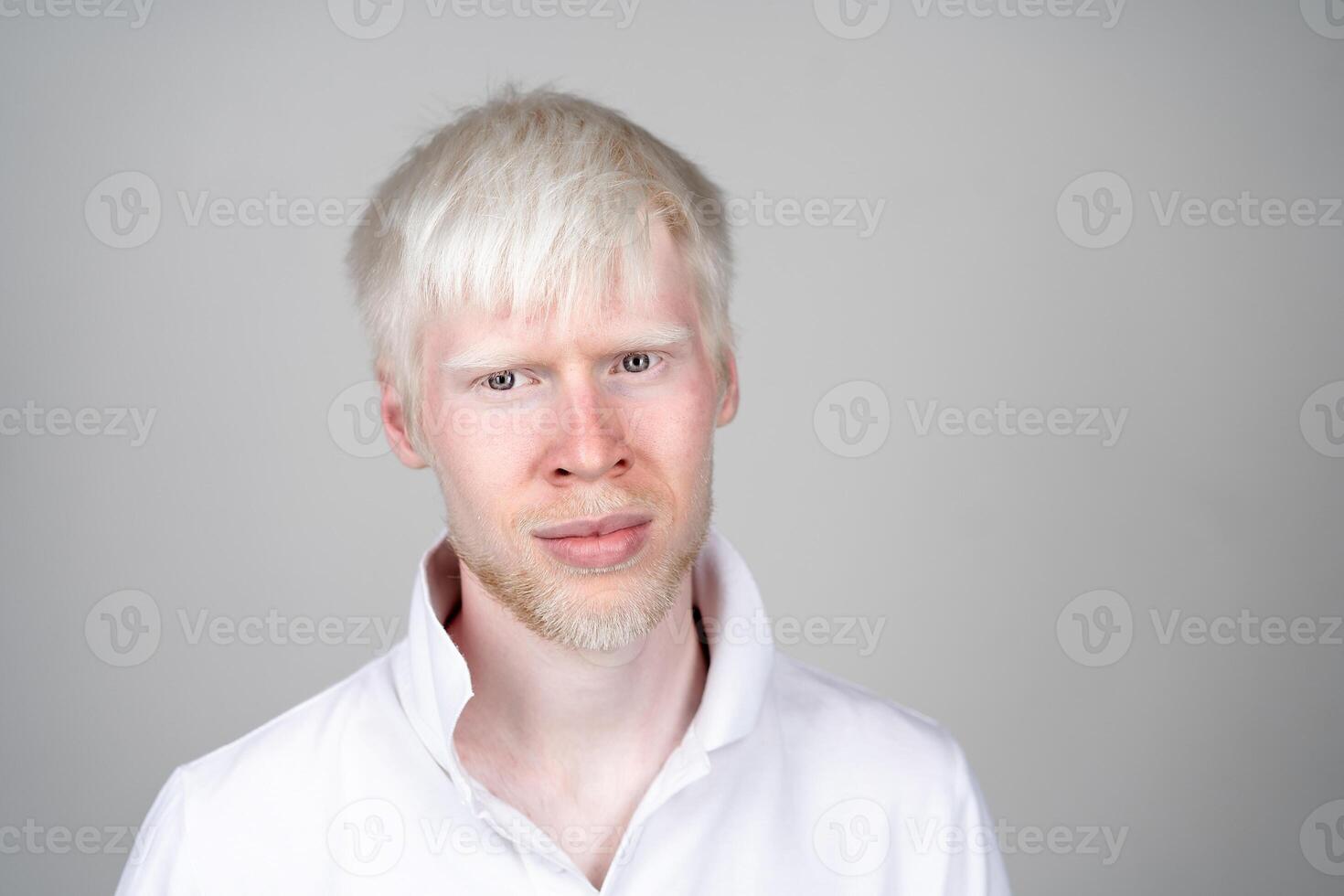 portrait of an albino man in  studio dressed t-shirt isolated on a white background. abnormal deviations. unusual appearance photo