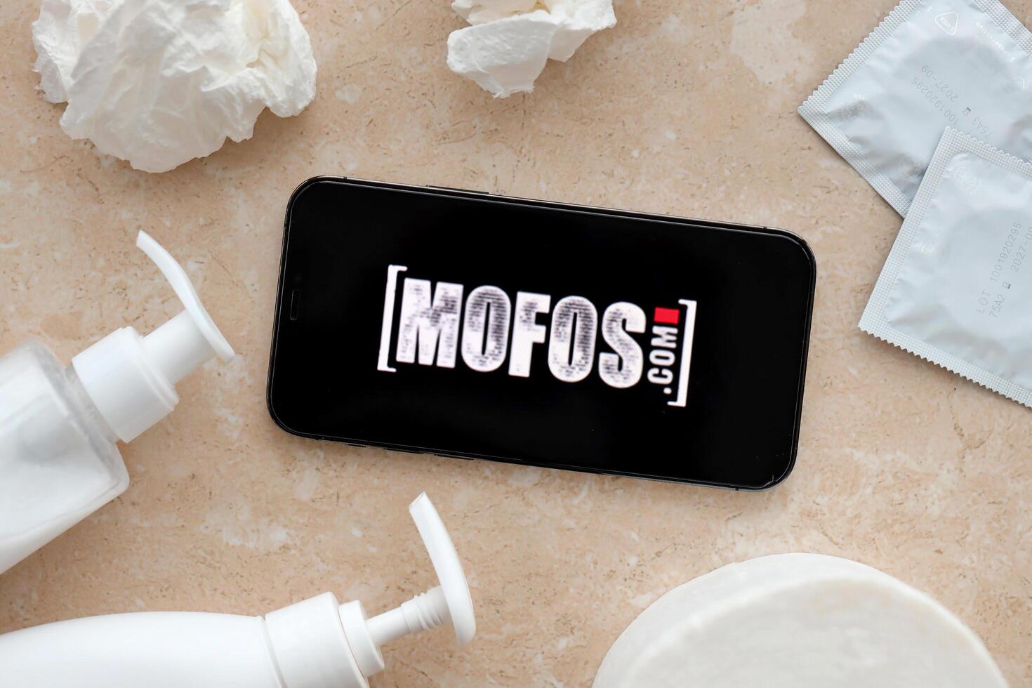 KYIV, UKRAINE - JANUARY 23, 2024 MofosCom adult content website logo on display of iPhone 12 Pro photo