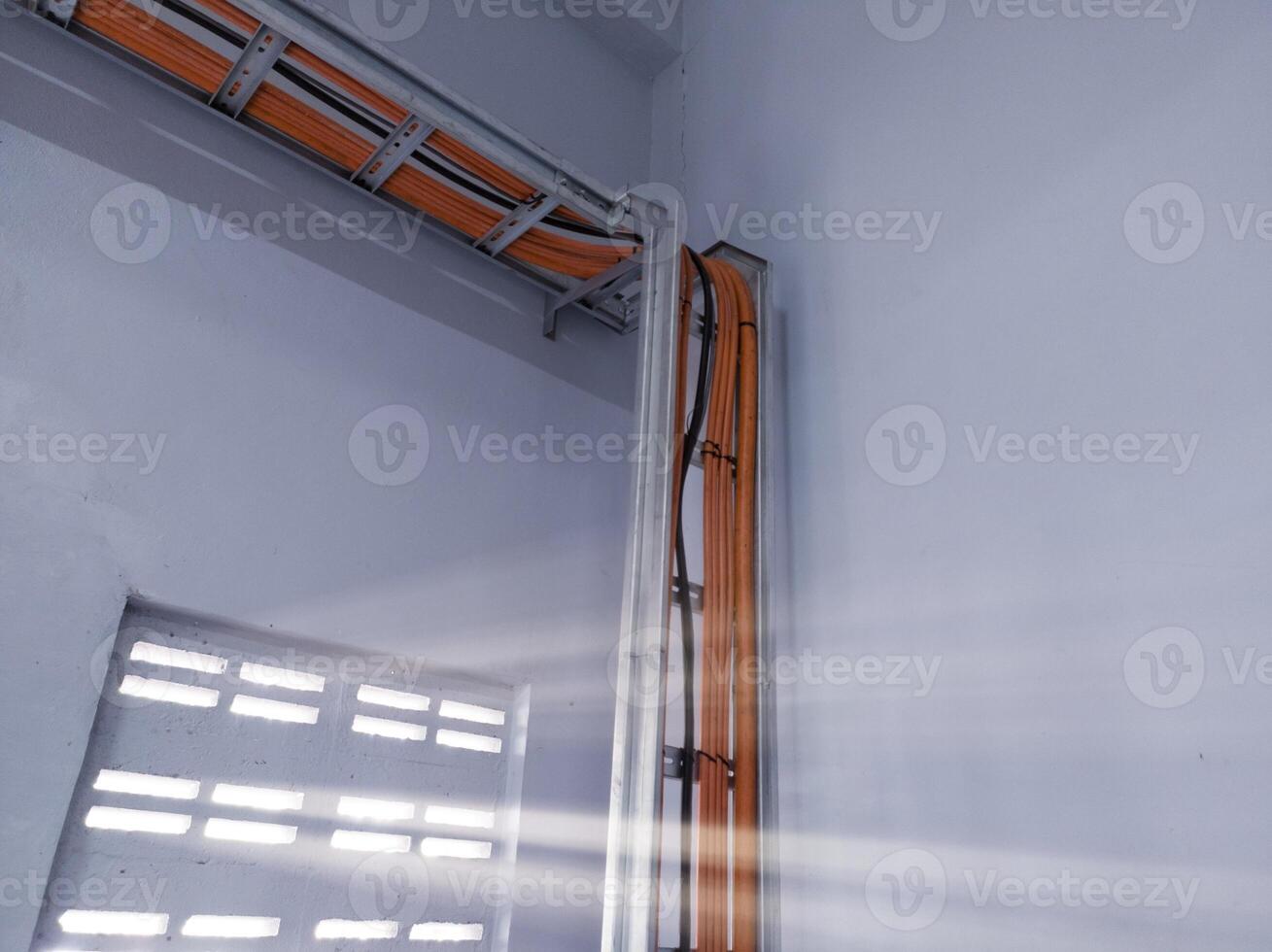 Installation cables power on the tray with spesification  fire temperature resiatance, Installation cables tray on the wall power house. power cables out inverter solar panel. photo