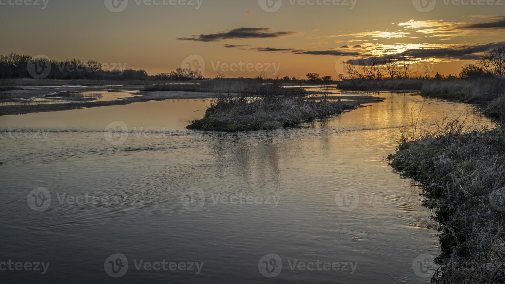 springtime sunrise over wide and shallow Platte River near Kearney, Nebraska photo