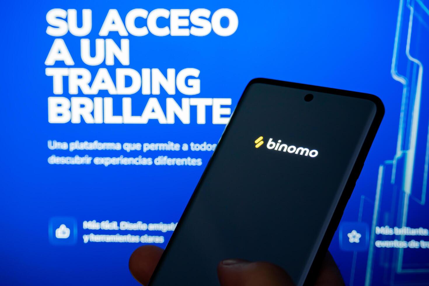 Cordoba Province, Argentina, March 11, 2024, Trading and cryptocurrency application called Binomo running on a mobile phone. photo