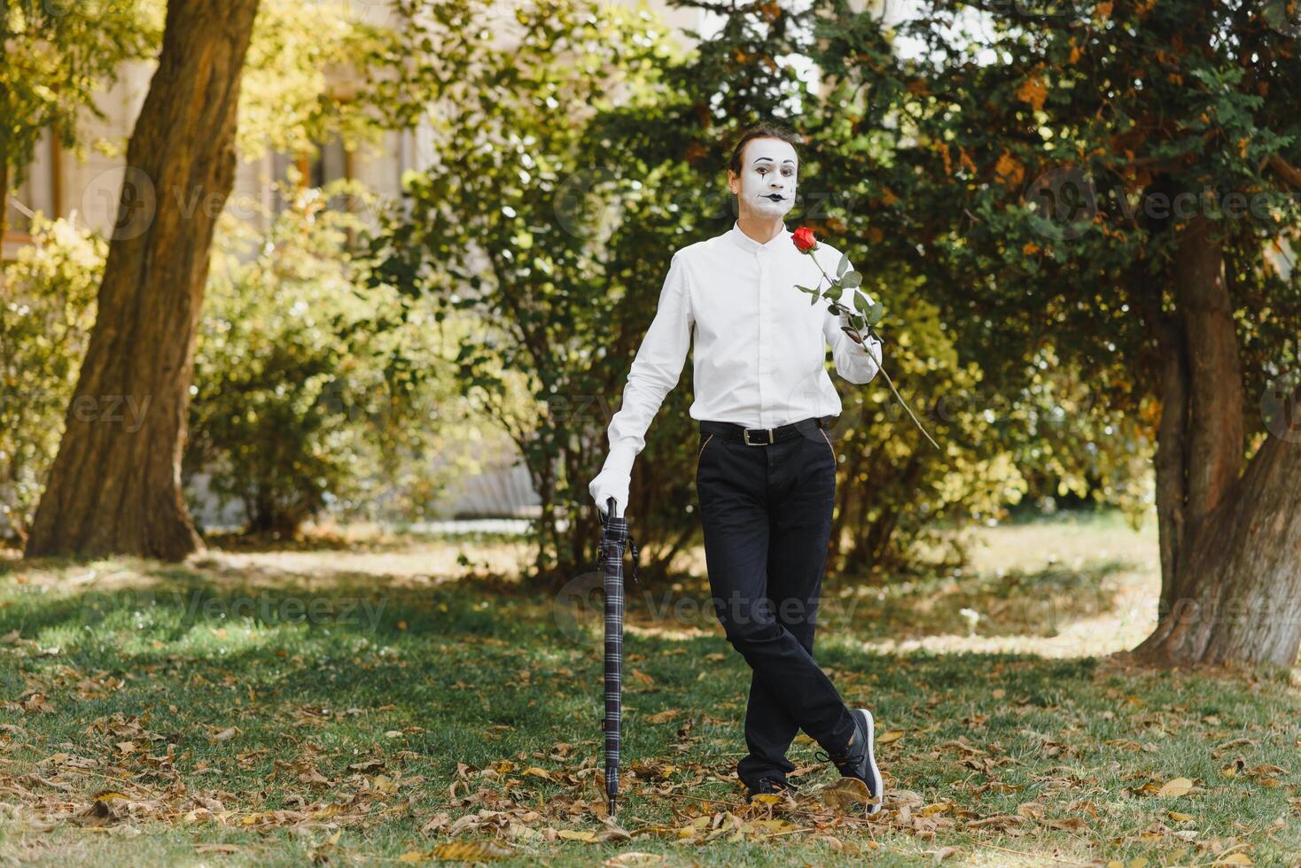 Portrait of a man, artist,clown, MIME. Shows something. Mime actor shows different emotions. photo