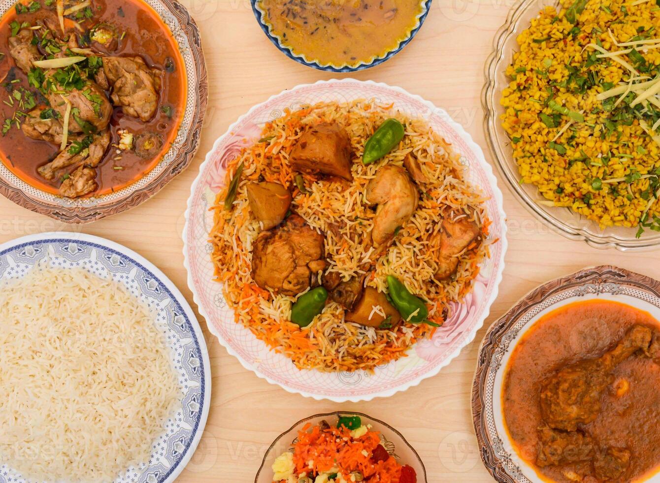 Assorted indian spicy food chicken biryani, Chicken nihari, daal chawal, Daal maash, zarda or jorda rice served in dish isolated on table top view photo