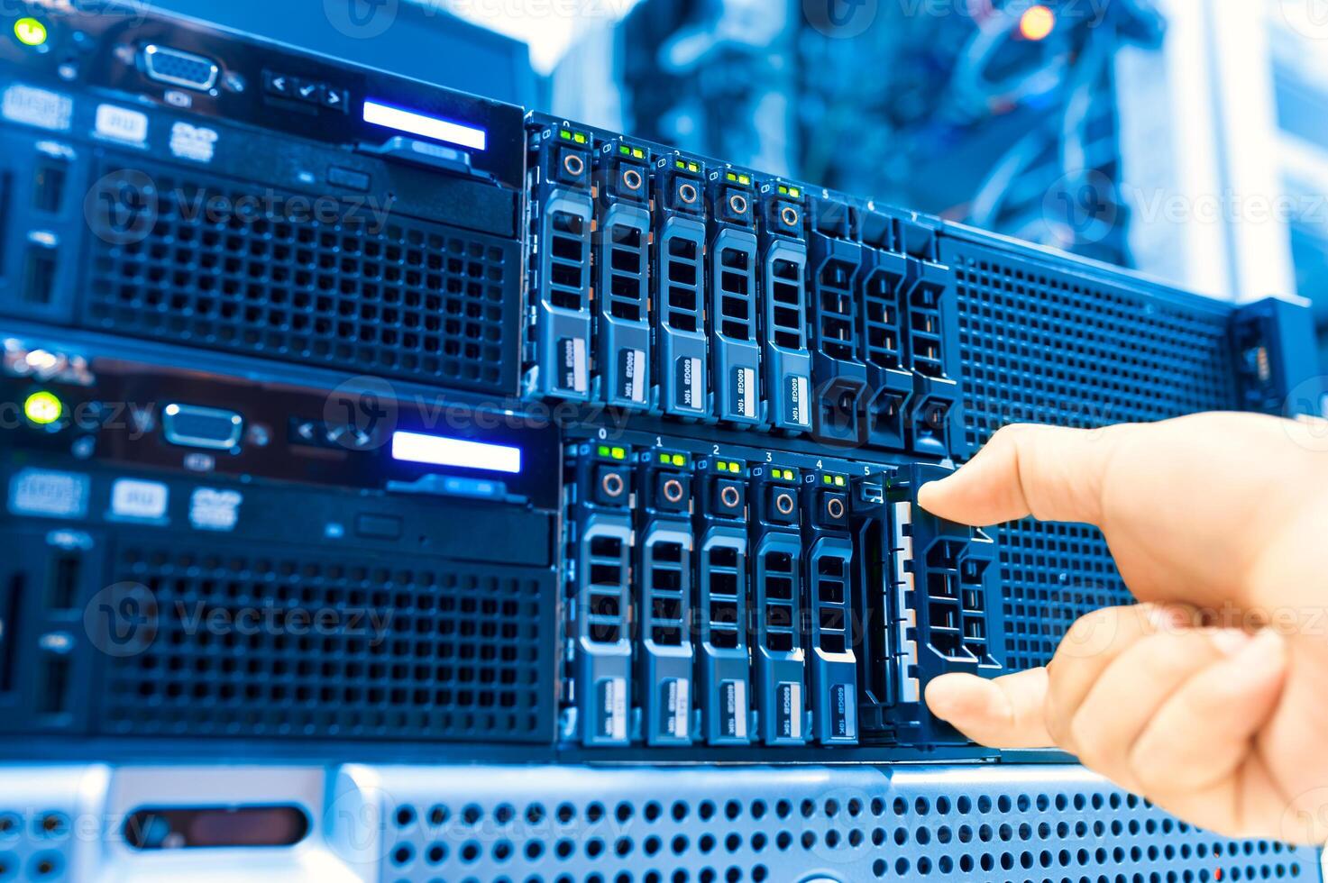 IT engineer repairing a server in a datacenter photo