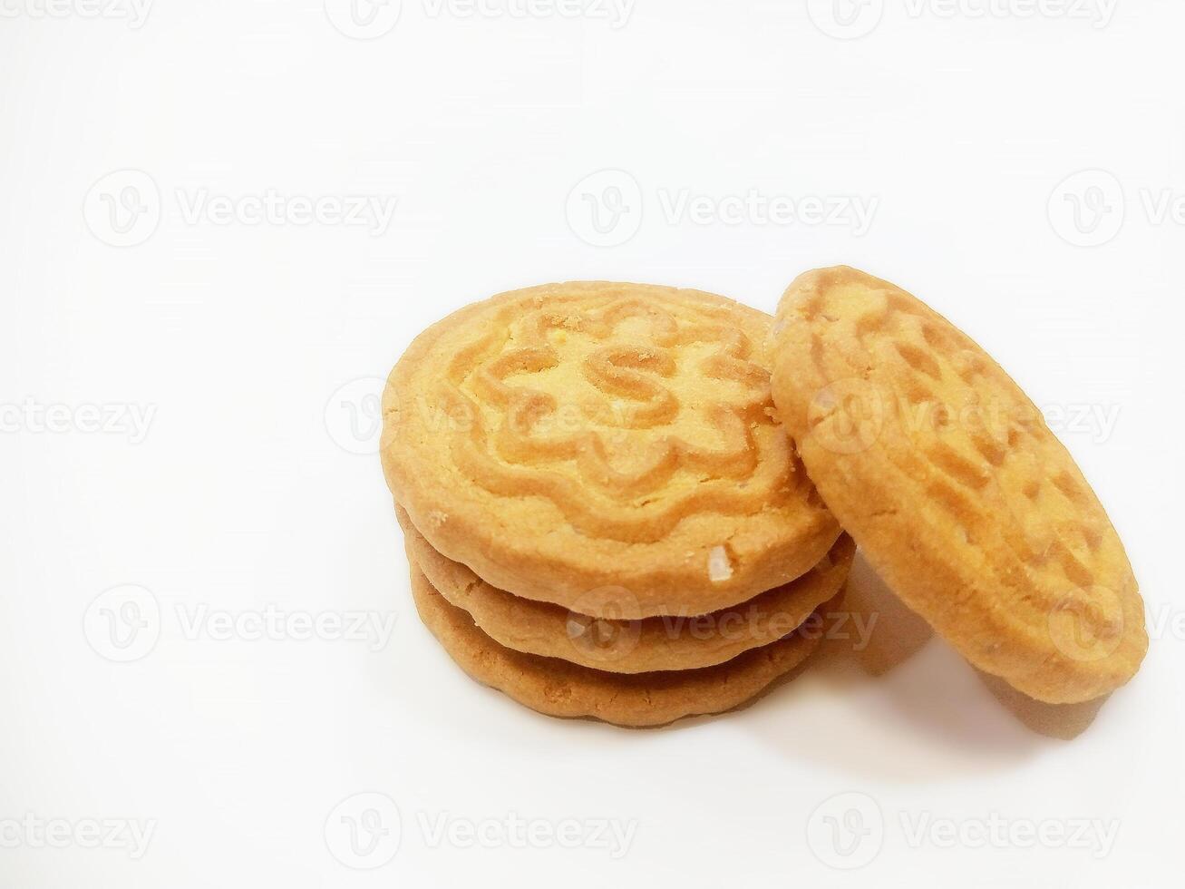 Wheat biscuits BISCUITS - A stack of delicious wheat round biscuits with a few crumbs isolated on white photo