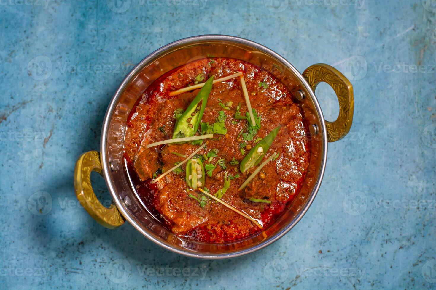 Spicyy mutton karahi masala with napkin isolated on wooden table top view of indian, pakistani food photo