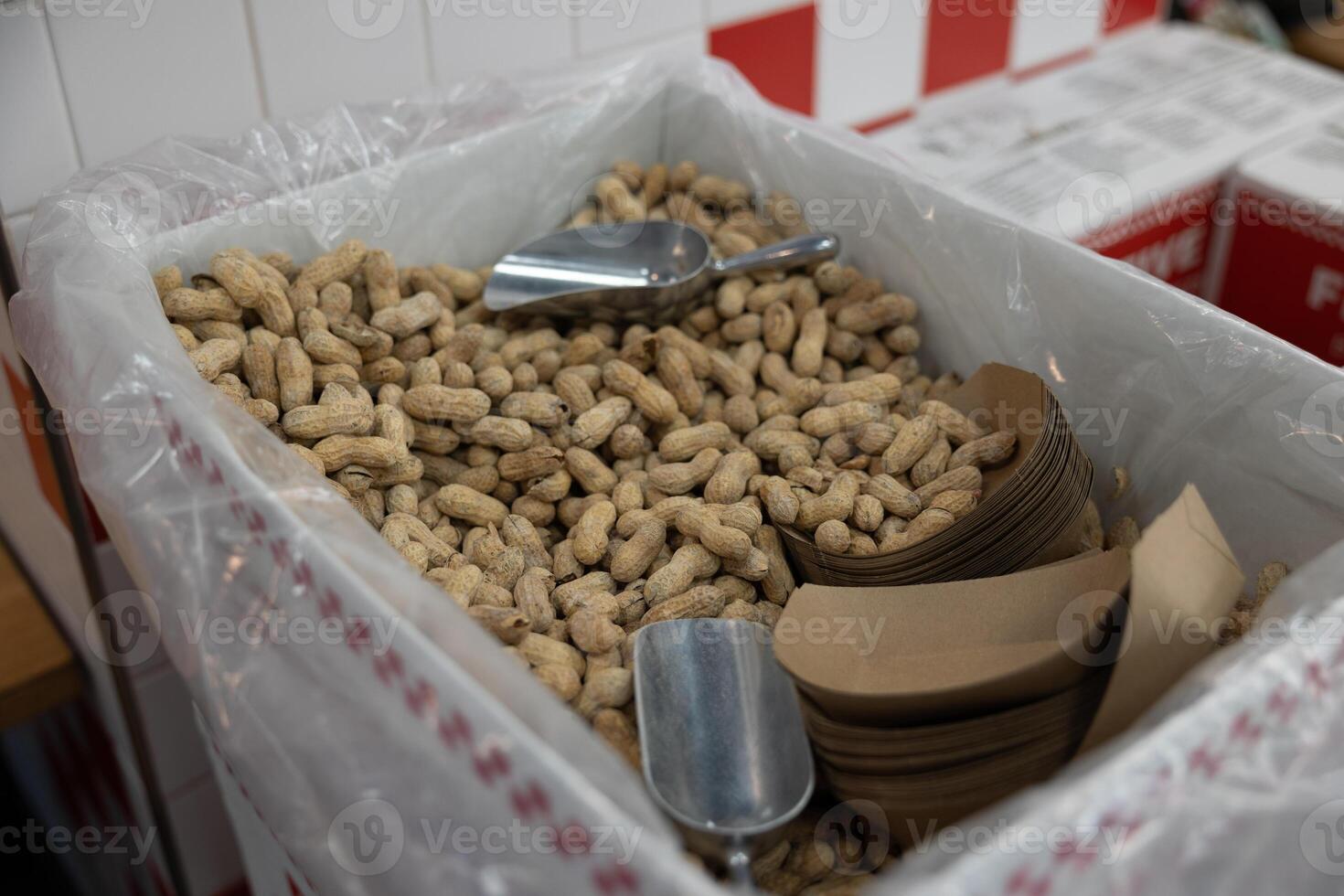 Fresh peanuts with shells box.Iron spatula for set of peanuts.Elephant delicacy photo