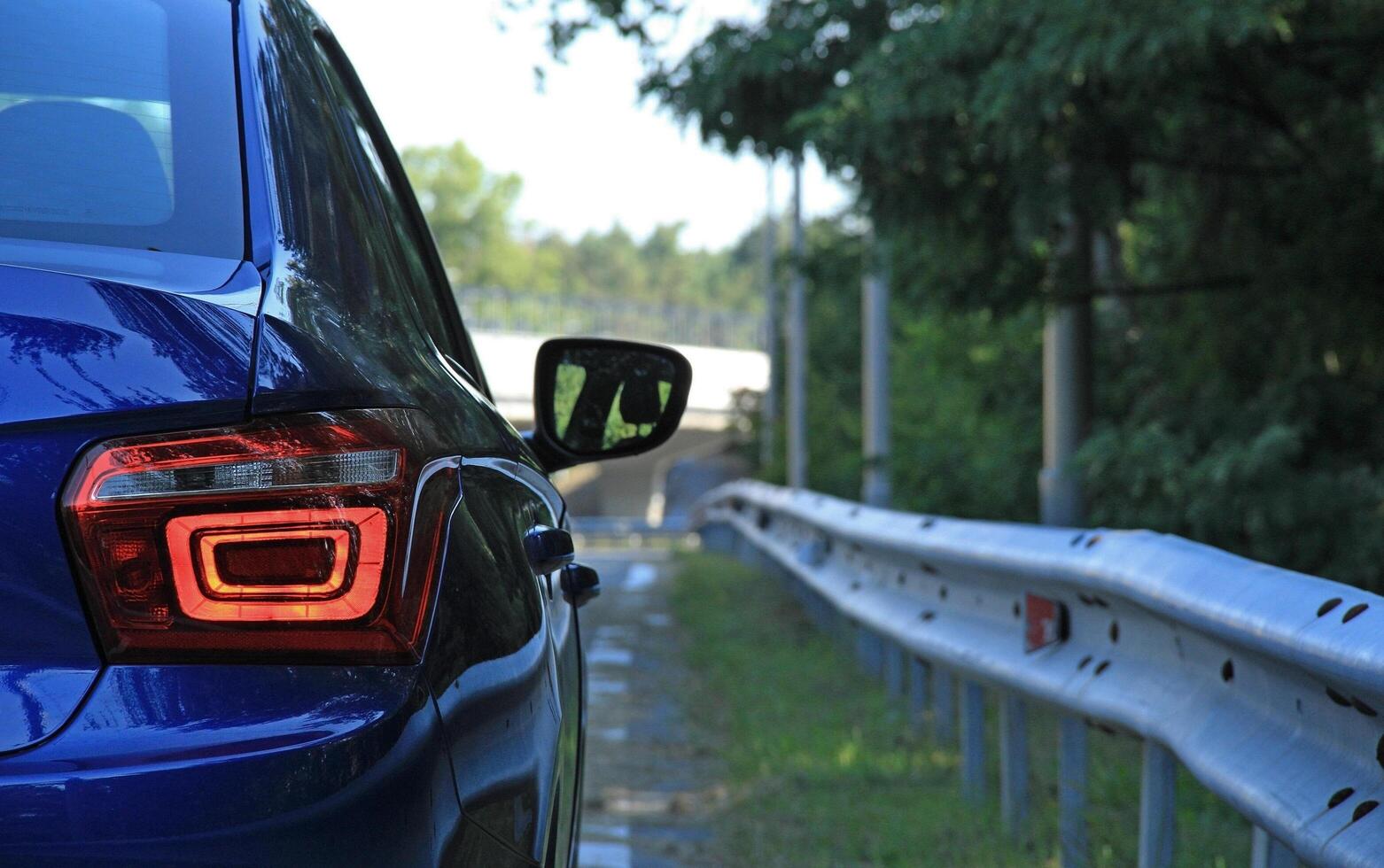 Backlights of blue vehicle on the fenced highway ready to travel photo