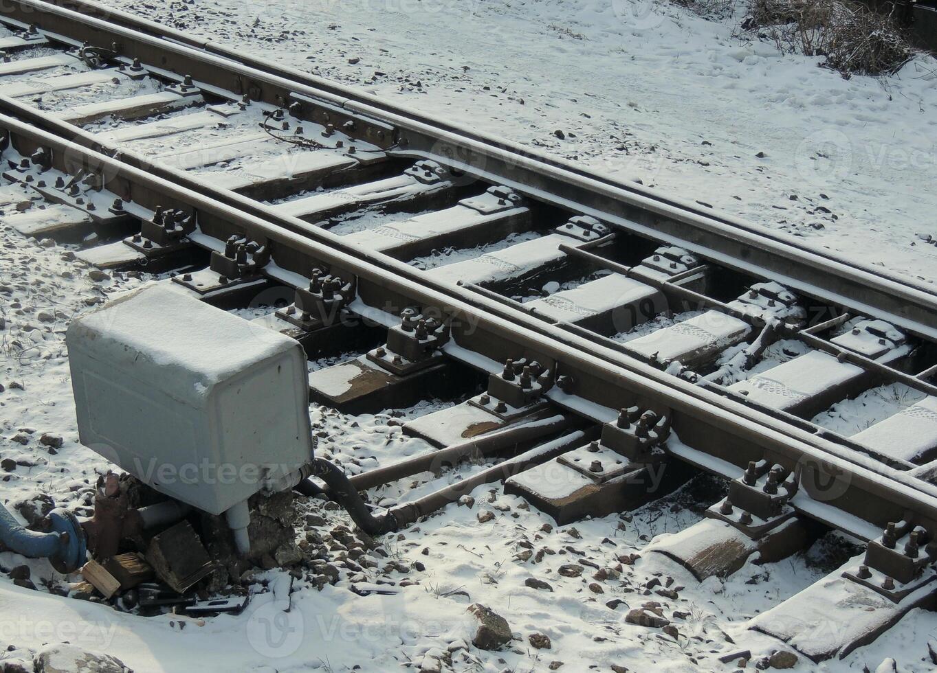 Track switch box near spare railway track at winter photo