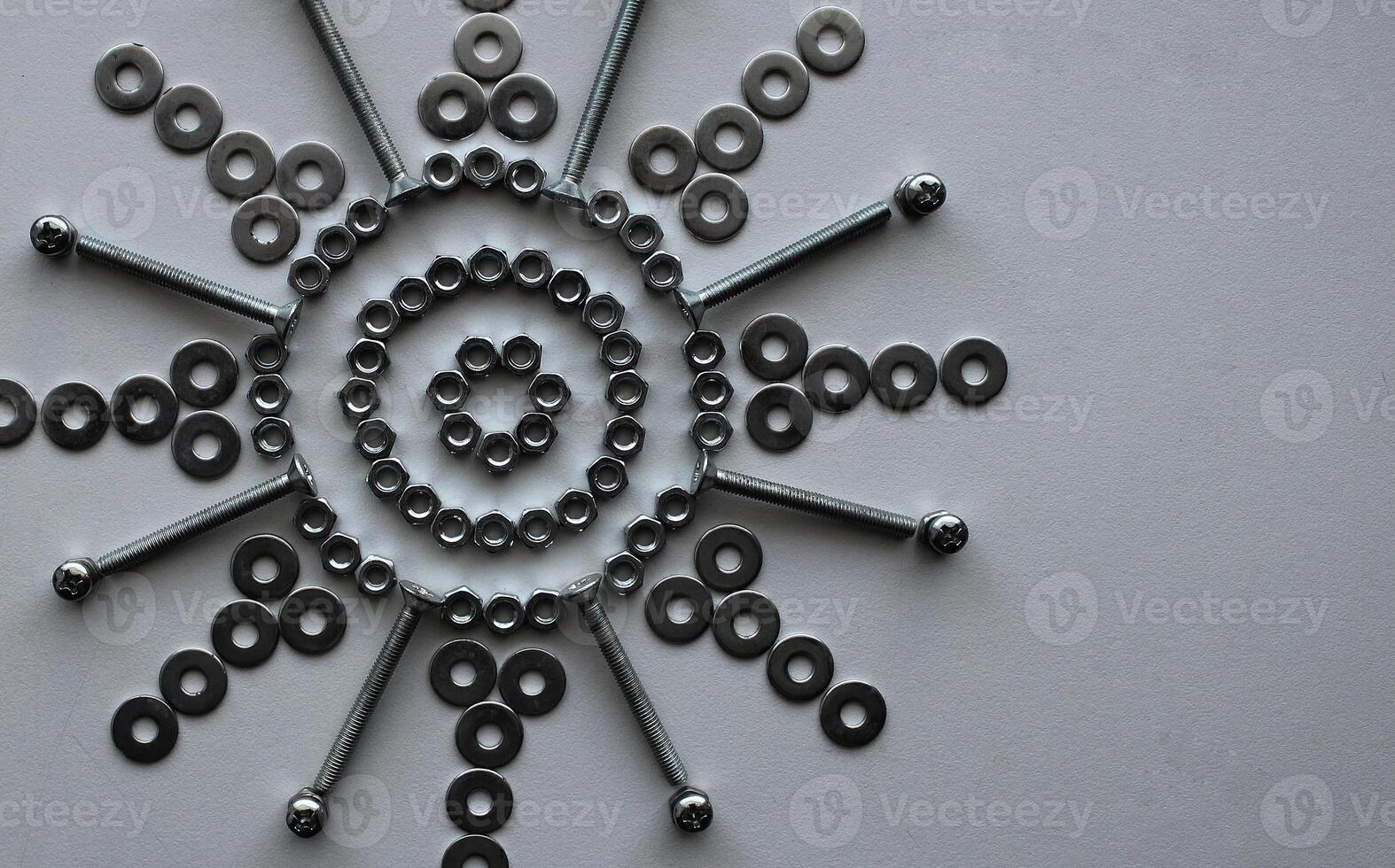 Concept For Steel Art Design. Steel Hardware Items Laid Out In Flower Pattern On White Surface At A side Of Image photo
